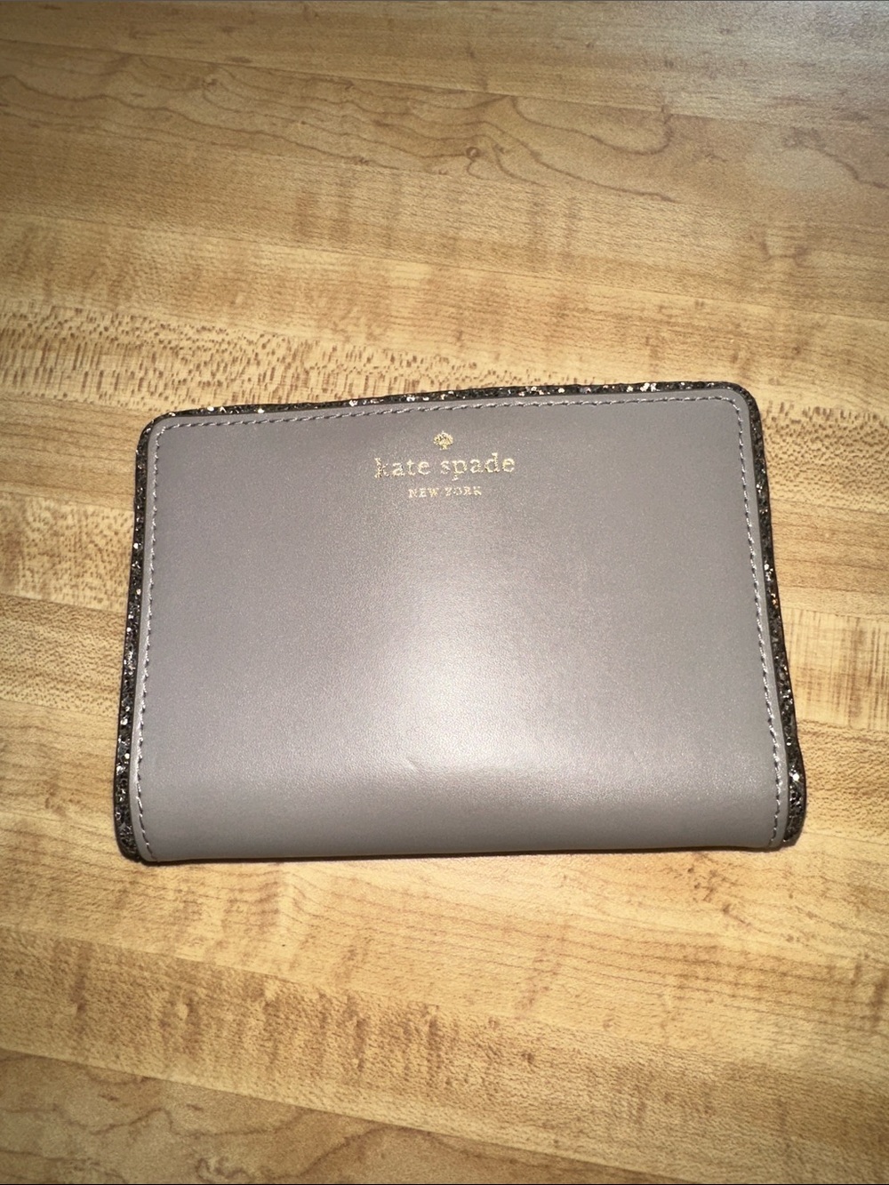 Kate Spade gray “Tellie”  leather bifold wallet with metallic trim